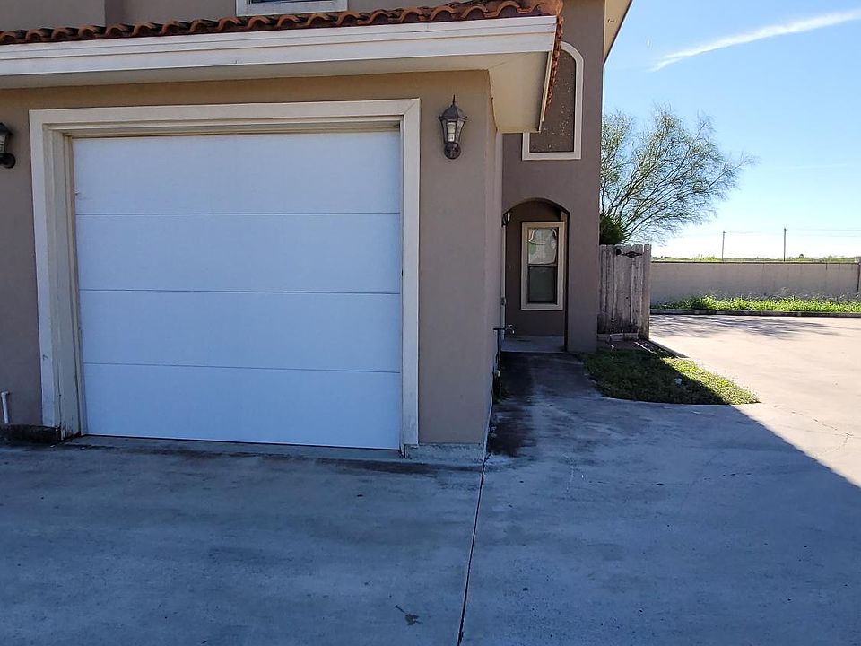 front and garage, with another parking for a car or two beside the property