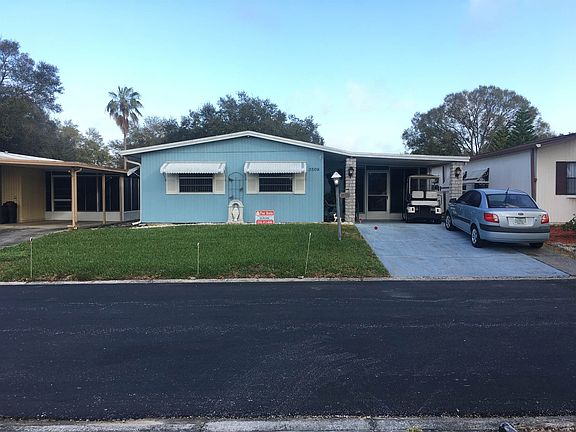 Front of Home w/ Attached Carport