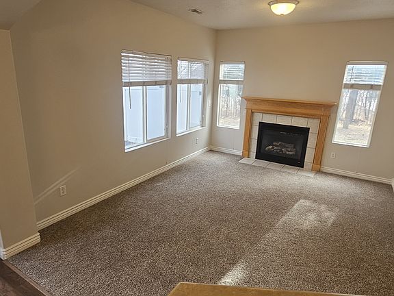 Living room with gas log fireplace, lots of natural light