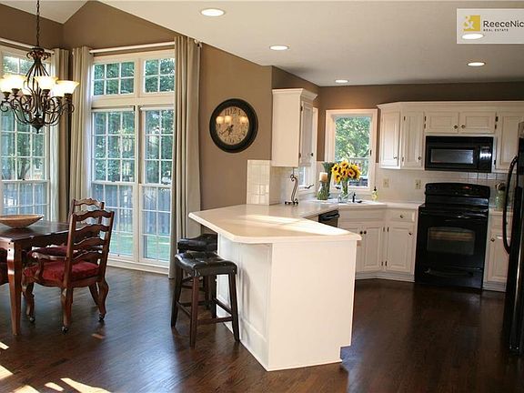 Freshly painted kitchen cabinets and woodwork throughout main level.  Plenty of countertop space for entertaining.  Breakfast room has wall of windows to let in natural light.  An updated light fixture and vaulted ceiling.