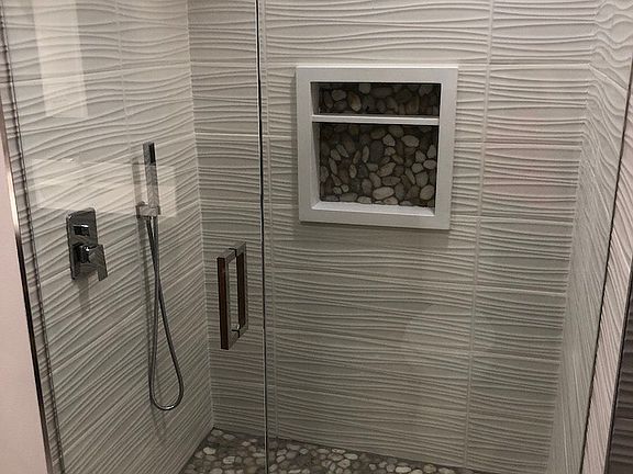 Rain shower head in one bathroom.