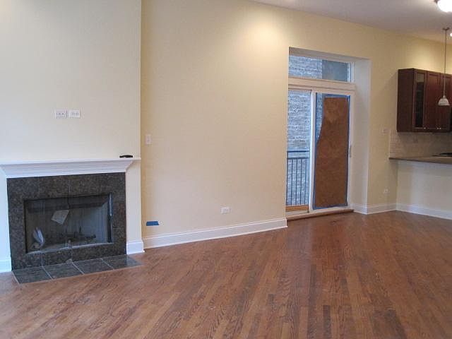 LIVING ROOM WITH GAS FIREPLACE / DINING AREA WITH JULIET BALCONY
