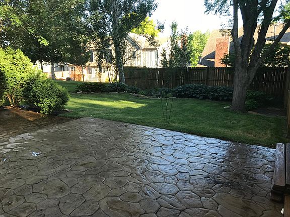 Beautiful landscaped backyard with stamped concrete patio.