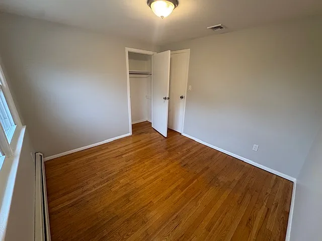 Bedroom 1: features natural lighting, hardwood floors and closet