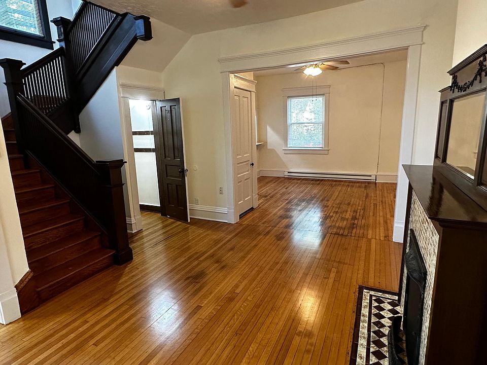 Enormous and luminous 1st floor with room for dining area, living room, study, flanked by entryway, non-functional fireplace, stairwell to bedrooms and bathroom, and breakfast bar off the kitchen.
