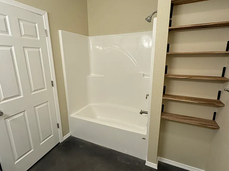 Spare bathroom, tub and shelves