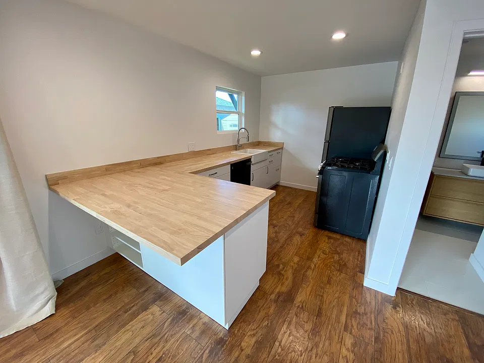 Brand new kitchen with dishwasher, large farm house sink, large fridge. Unit has canned lights throughout.