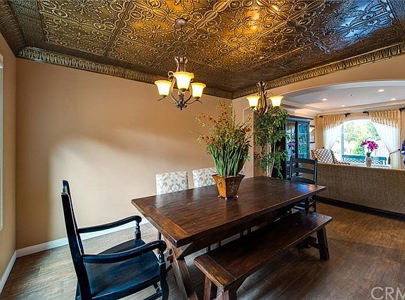 The elegant Dining Room is graced by a custom tin ceiling.