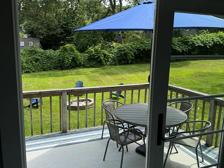 Deck Adjoining to kitchen; view of yard and fire pit.