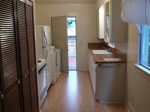 Galley Kitchen with washer and dryer and door to back yard