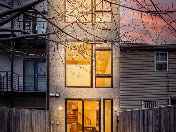Rear of the house. What you see here: kitchen on the first floor, living room on the second, and smaller bedroom on the third.