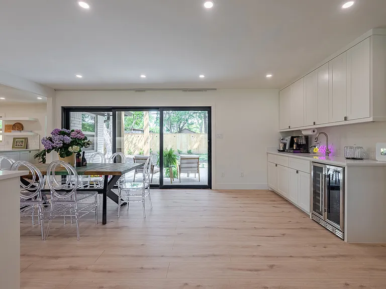 Dedicated dining space perfect for family meals and hosting guests, enhanced by large sliding glass doors that seamlessly connect indoor and outdoor living.
