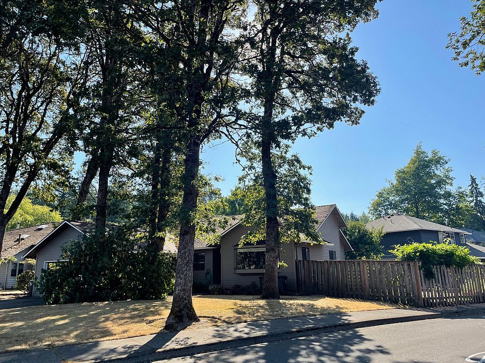 Large front lawn and mature oak trees.