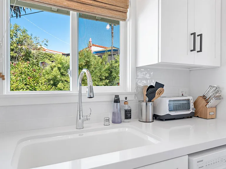 Light and bright kitchen, fully stocked with housewares and dishes