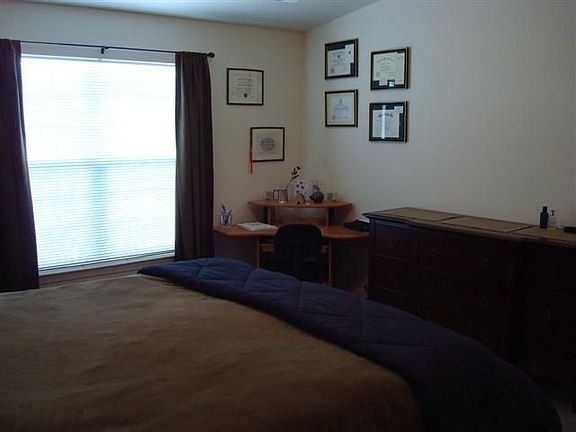 Large dual sliding window illuminates master bedroom.