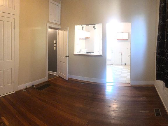 Living room looking into kitchen. Bathroom is doorway on the left.