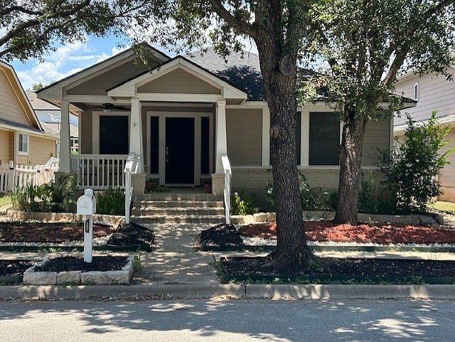 This is a picture of the front of house with a xeriscape yard. The river rock and mulch were added three months ago. There are also two nice shade trees out front.