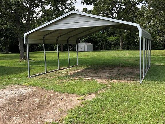Covered Carport Parking and Storage shed included!