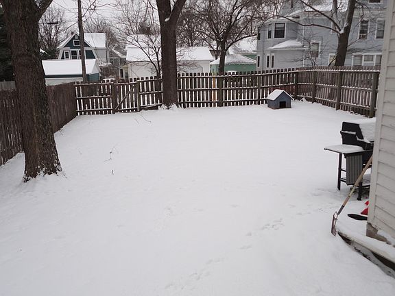 backyard looking off deck. Three parking spots outside fence go with the house in the alley