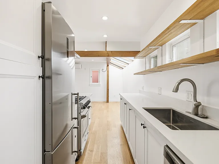 View of the kitchen going into the living room