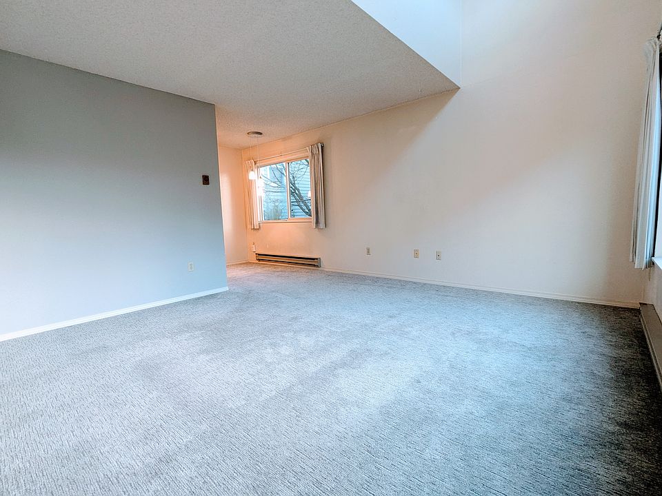 Living and dining area with kitchen around the corner