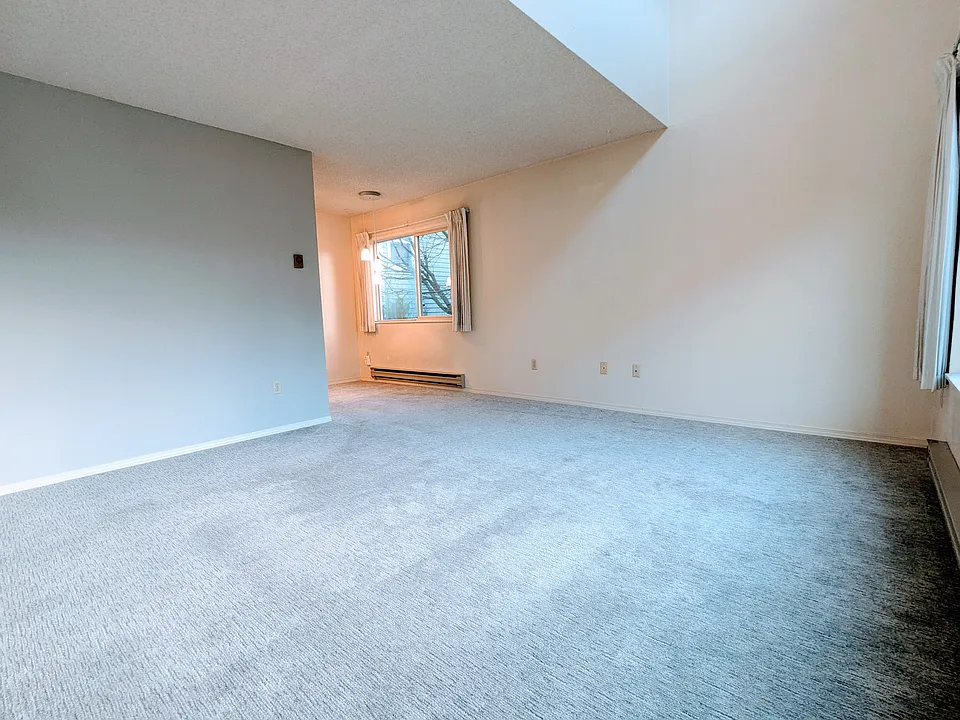 Living and dining area with kitchen around the corner