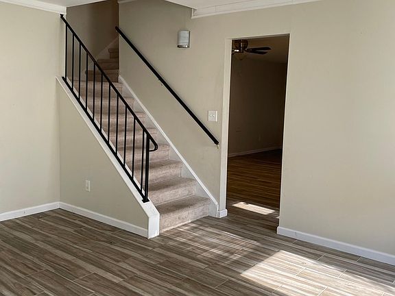 Stairs to upstairs and entrance to kitchen