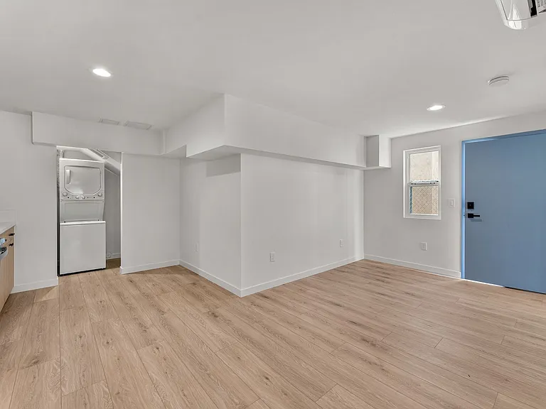Living room, dining room and kitchen with private laundry and storage