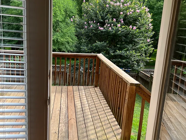 View from inside house to deck. Note lots of light inside home filtering into space