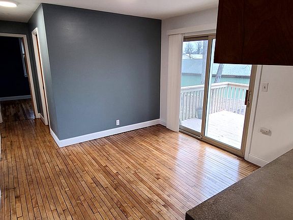 View from kitchen, looking at dining room and down hallway to bedrooms.