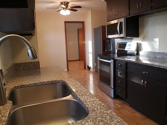 Kitchen with stainless steel appliances and granite countertop.
