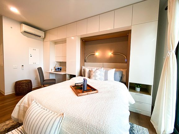 Front view of Murphy bed with 2 moveable over head lights for evening reading before bed.