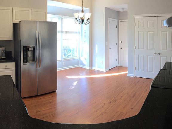Kitchen entryway from adjacent 2-car garage with new Samsung range and Stainless Steel Hood
