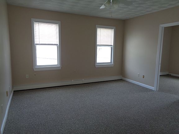 Front Living Room with NEW Carpets and New Paint. NO wall mounted TV's allowed. NO additional wall mounted shelving allowed. No additional wall mounted rods/hooks allowed.