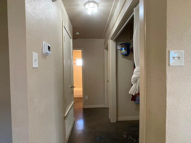 Hall to secondary bedrooms. Laundry closet on right. Will install bi-fold doors & add washer and dryer