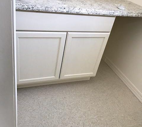 Cabinet and counter in closet off first floor bathroom