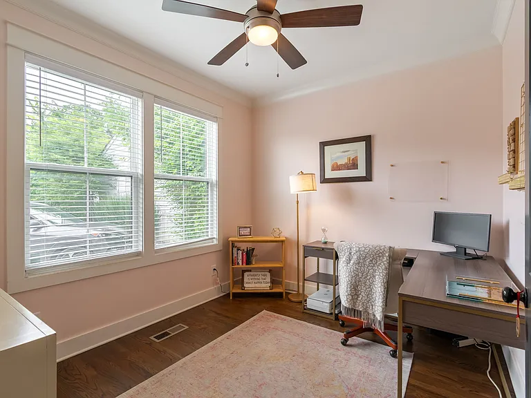 When you enter, you'll find a dedicated home office flooded with natural light. 
(Cabinet- left and area rug remain)