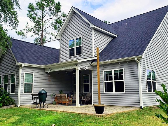 Rear covered porch with stone patio