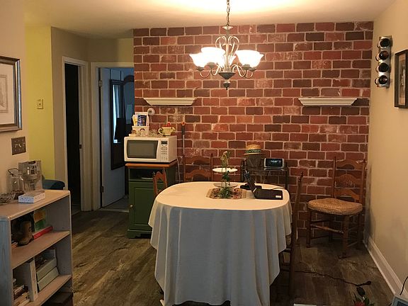 Dining area with rustic brick wall (This photo does not show the freshly painted walls)