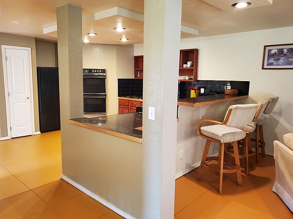 Kitchen offers a double oven, stove top, full size refrigerator, pantry and breakfast bar
