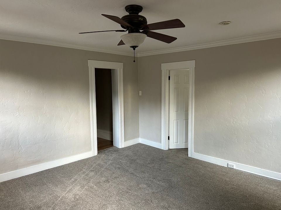 Living room facing hallway and bedroom.