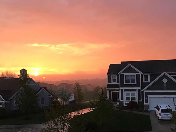 House w/ sun rising behind