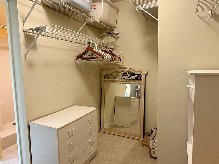 One side of the HUGE Primary walk-in closet.