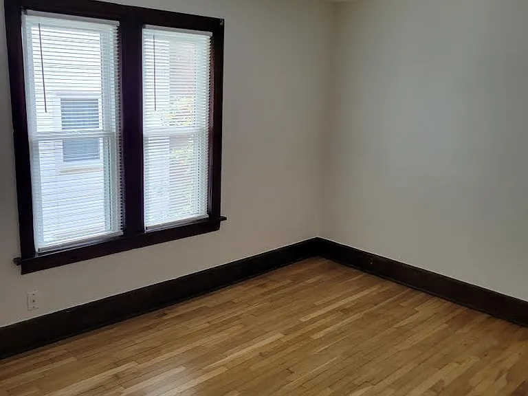 Second bedroom with ceiling fan and new windows.