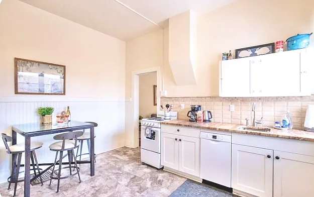 Electric range, Bosch Dishwasher and sink and garbage disposal in the Kitchen with lots of cabinets and fully stocked for cooking.