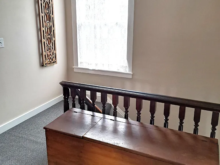 upstairs hall with antique chest for storage