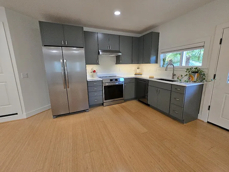 Everything is brand new. Induction range, full size fridge, dishwasher, disposal, under cabinet lighting. Microwave and movable kitchen island available.