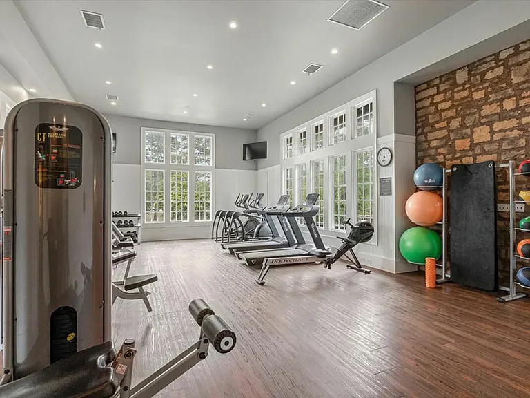 Get fit in the modern fitness center at The Cottages of Hattiesburg.