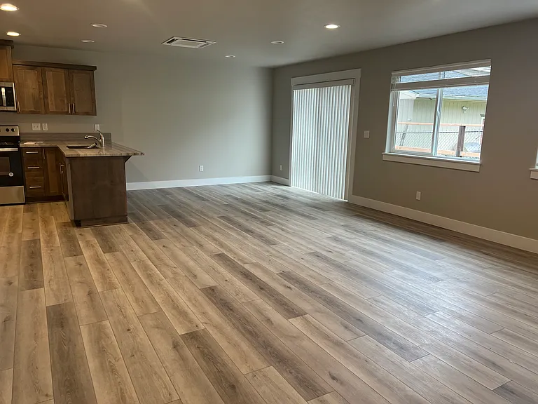 Living room, dining room and kitchen open floor plan. Leading to fenced back patio.