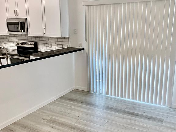Dining room and slider leading to large deck. Looking into kitchen.